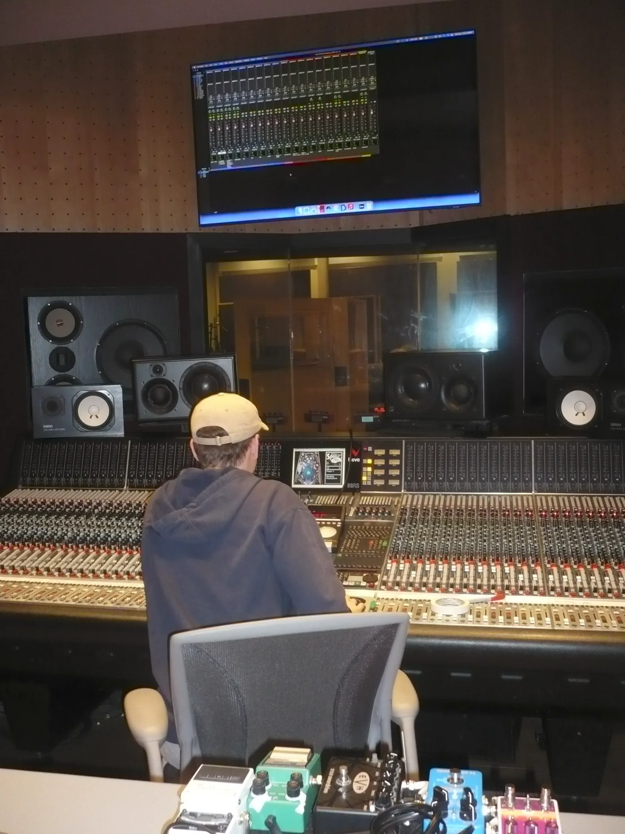 Nate at a large recording console in a studio control room