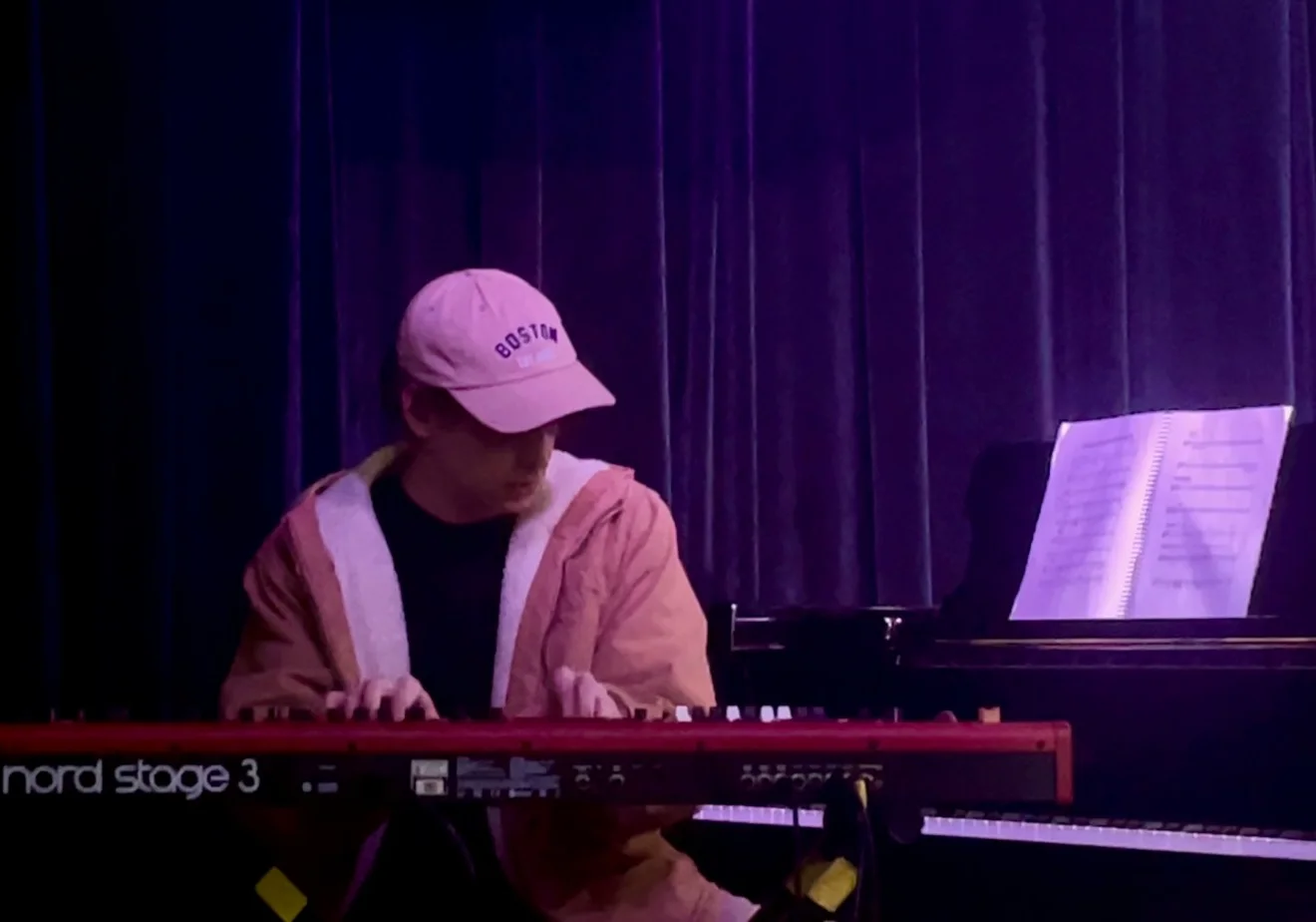 Nate on stage at a red Nord Stage 3, in a Boston cap
